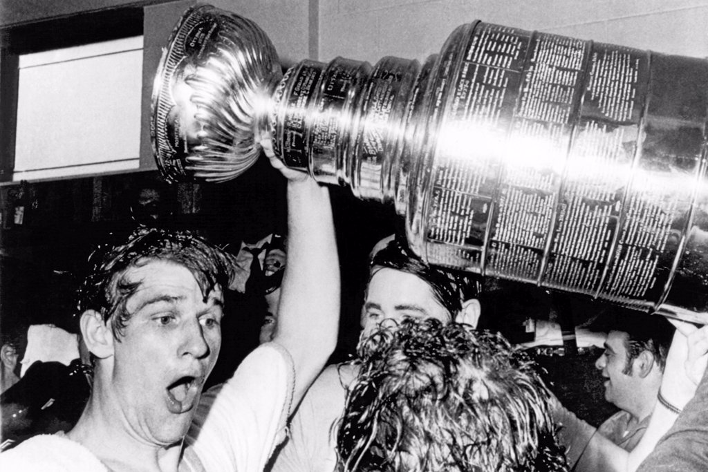 BOSTON BRUINS STAR BOBBY ORR WHOOPS AND HOLDS UP THE STANLEY CUP AFTER HE SCORED THE WINNING GOAL IN OVERTIME AGAINST THE ST. LOUIS BLUES AT THE BOSTON GARDEN