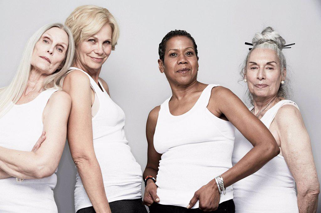 STUDIO PORTRAIT OF SENIOR WOMEN FRIENDS POSING FOR CAMERA