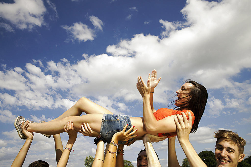 FRIENDS HANDS HOLDING UP YOUNG WOMAN