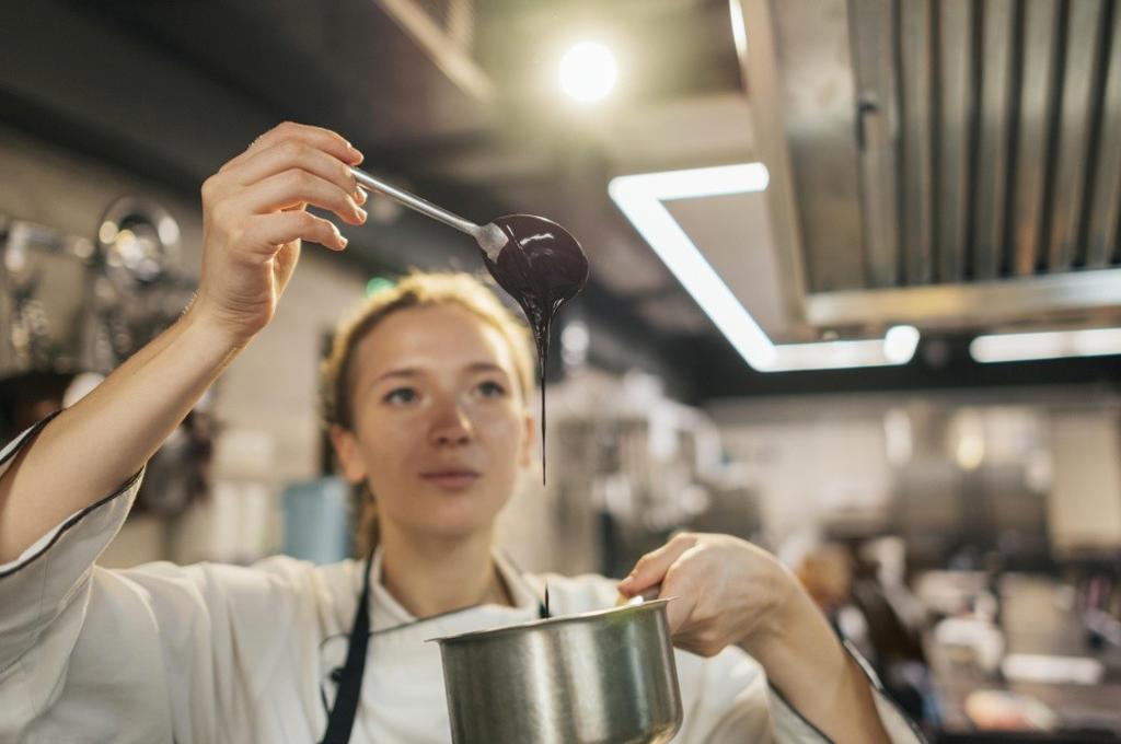 FEMALE CHEF CHECKING SAUCE