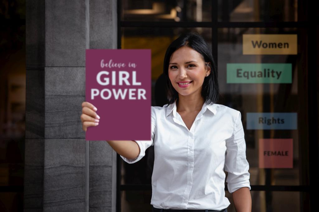 EQUALITY FOR WOMEN GENDER CONCEPT. A SMILING MIXED RACES WOMAN SHOWING A BOARD WITH MESSAGE GIRL POWER INTO THE FRONT