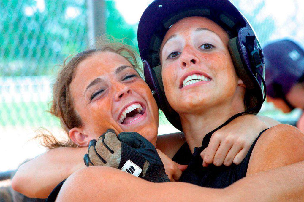 Softball Teammates Hugging Each Other And Laughing