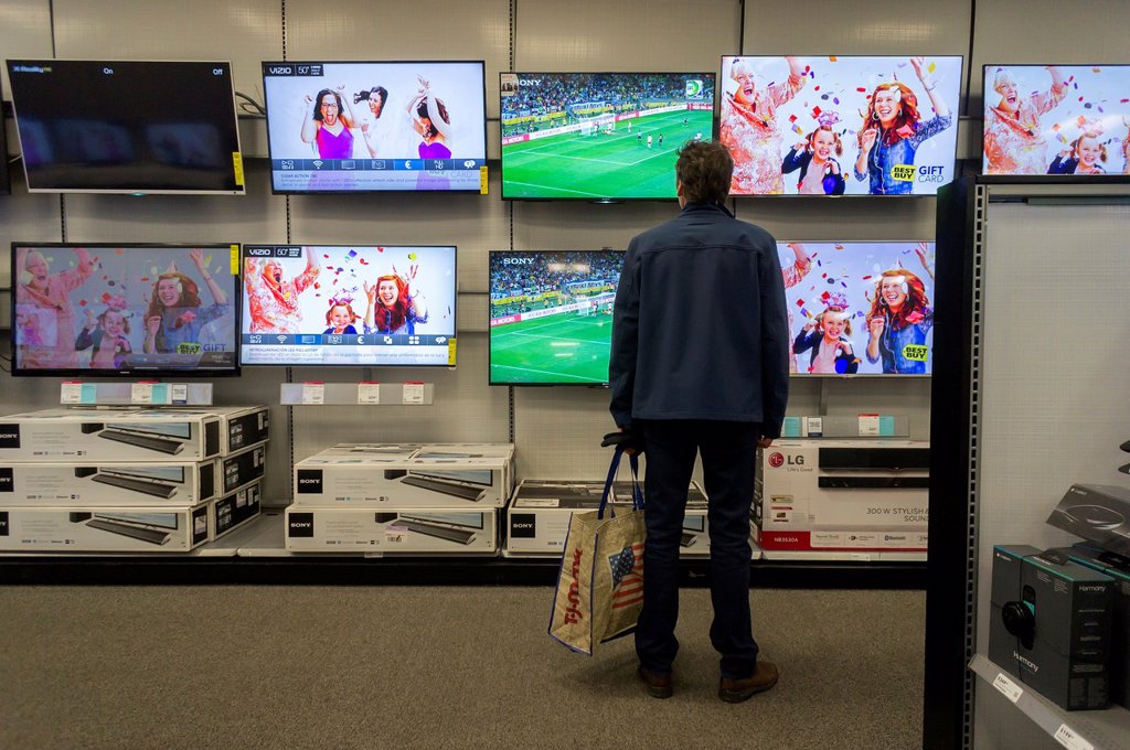A CUSTOMER BROWSES LARGE SCREEN TELEVISIONS IN A BEST BUY ELECTRONICS STORE IN UNION SQUARE IN NEW YORK