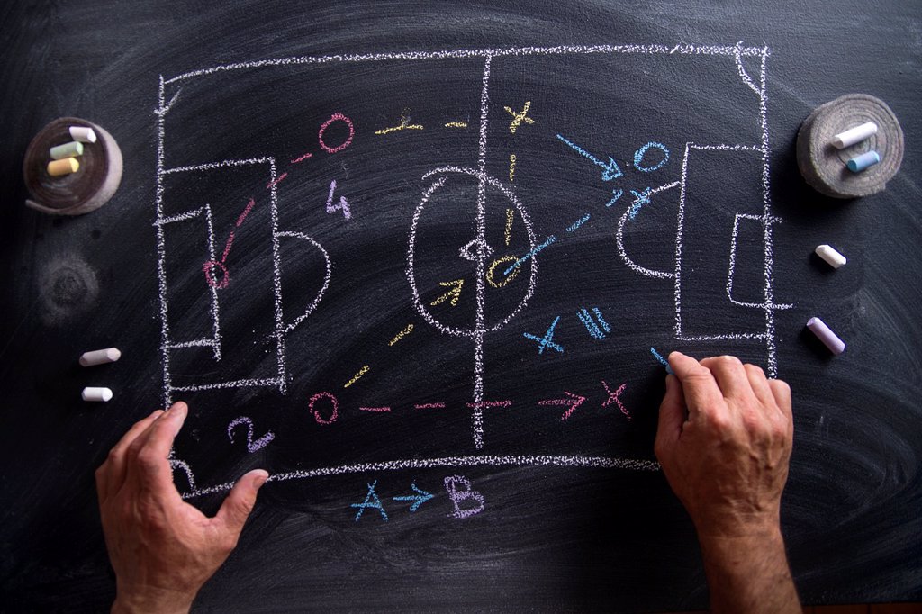 LESSON IN TACTICS AND THE FOOTBALL PATTERNS DRAWN WITH CHALK ON BLACKBOARD