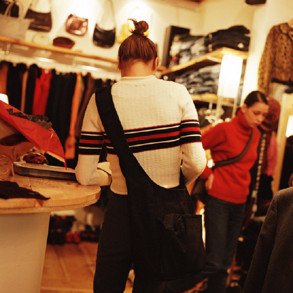 YOUNG WOMEN IN CLOTHING STORE