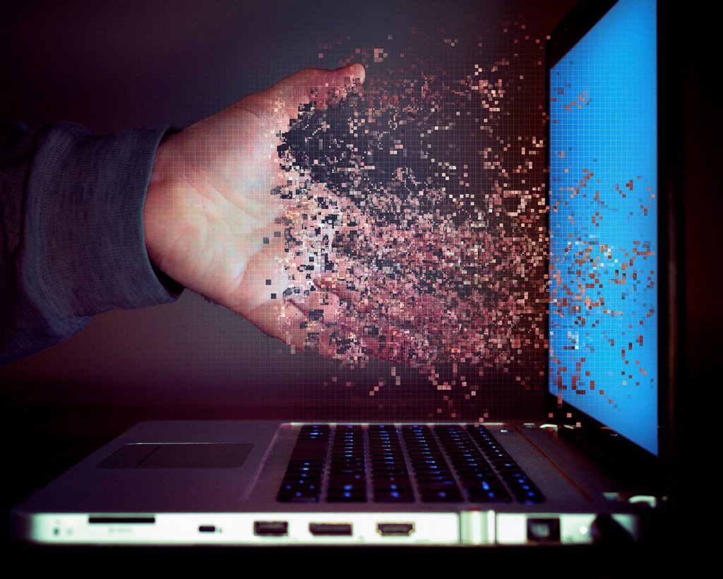 PIXELATED HAND OF CAUCASIAN MAN DISSOLVING INTO LAPTOP SCREEN