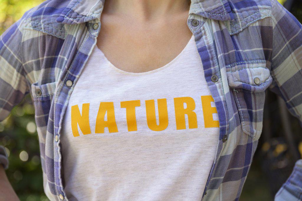 MIDSECTION OF GIRL (6-7) WEARING NATURE T-SHIRT