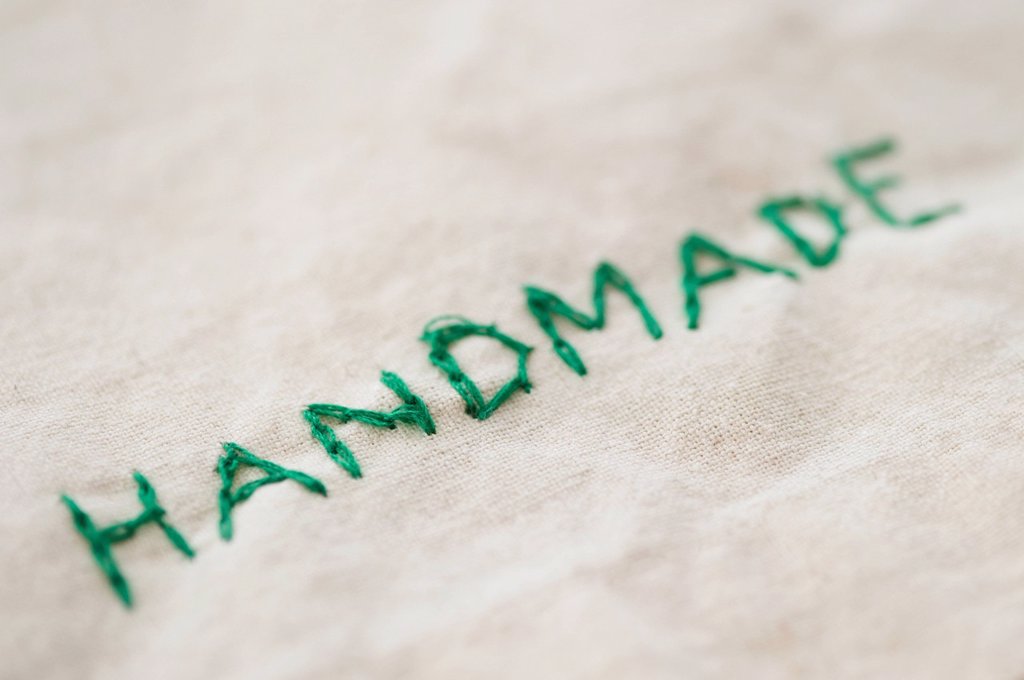 CLOSE UP OF EMBROIDERED HANDMADE WORD