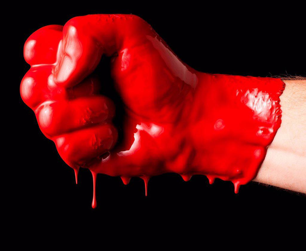 HUMAN FIST COVERED WITH RED PAINT