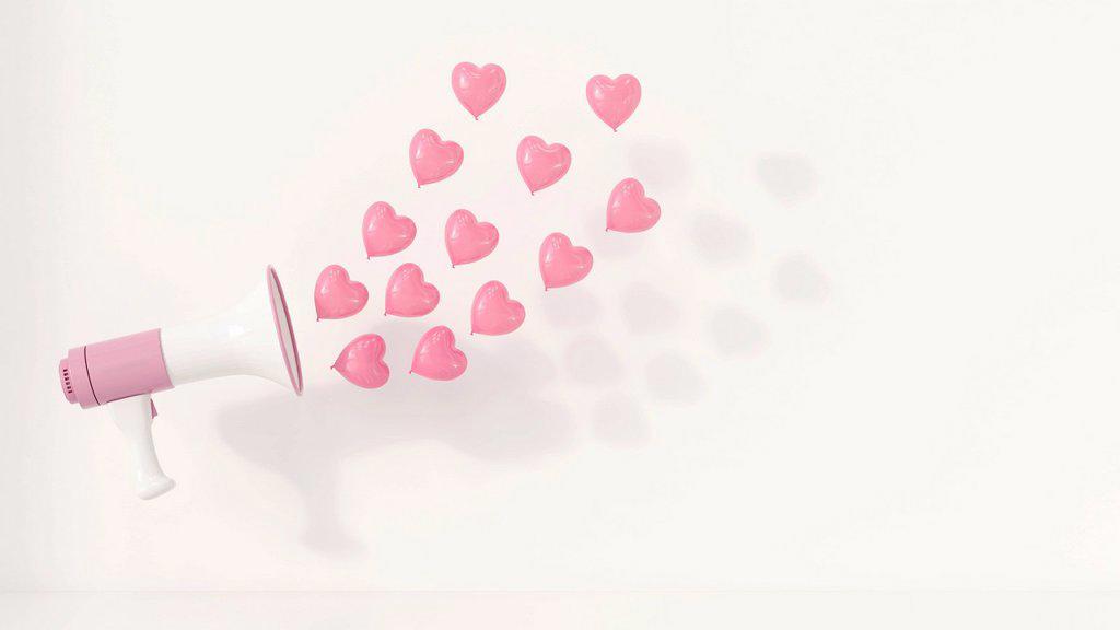 MEGAPHONE WITH PINK HEART-SHAPED BALLOONS AS SOUND WAVES