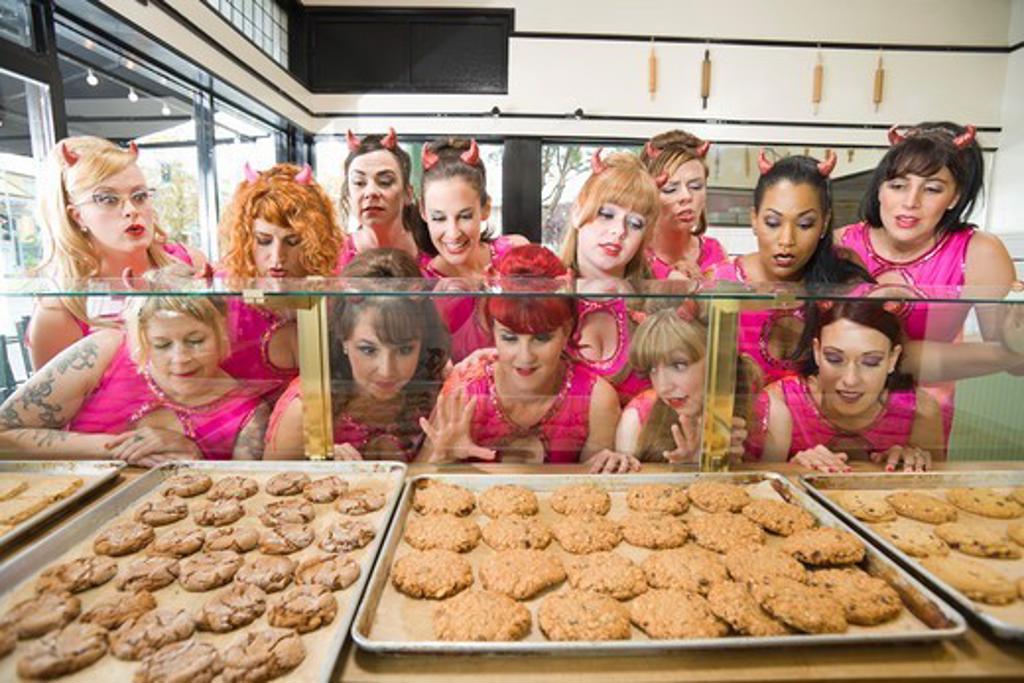 WOMEN WEARING DEVIL HORNS AT A BAKERY