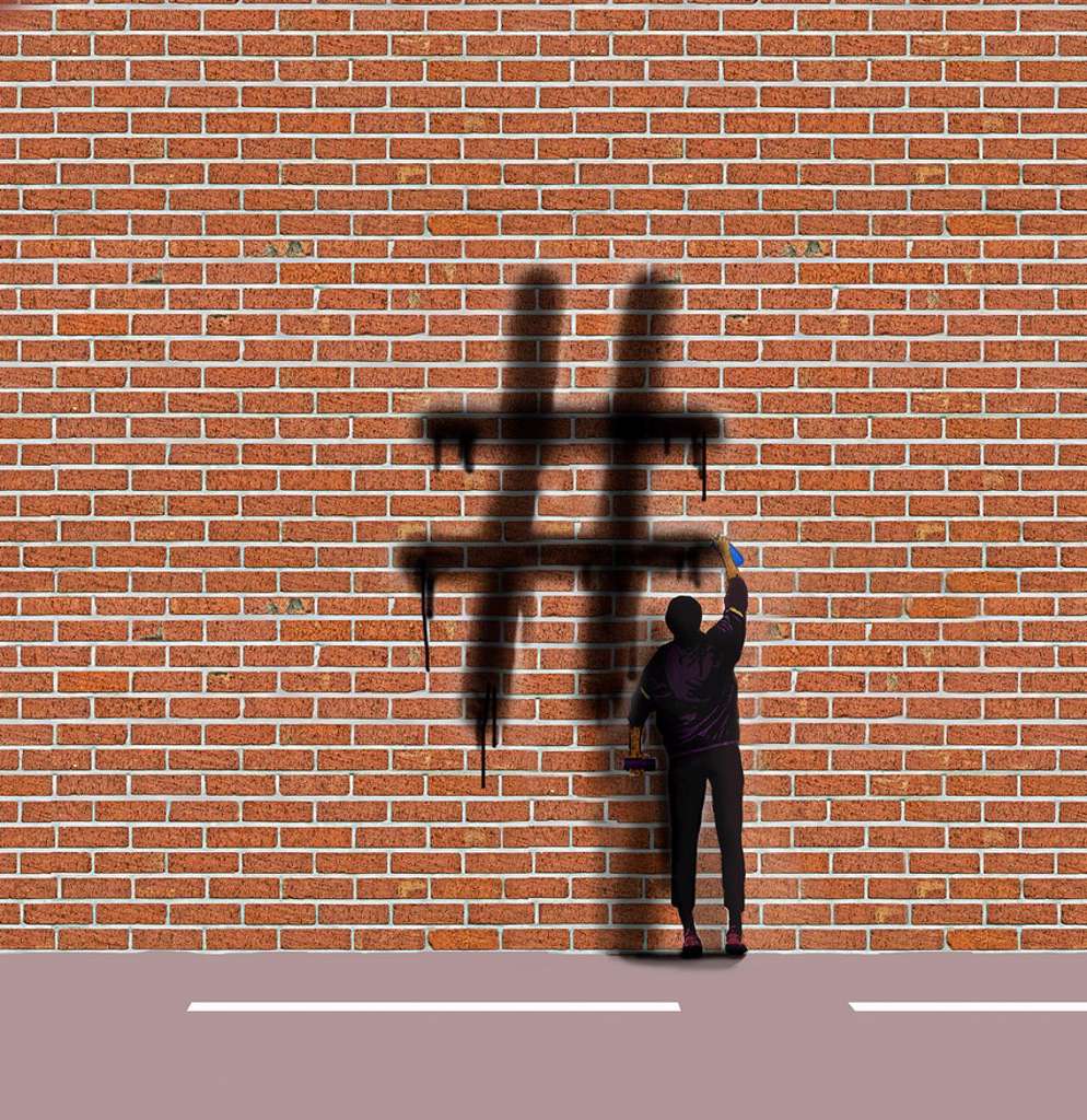 GRAFFITI ARTIST SPRAYING HASHTAG SYMBOL ON WALL