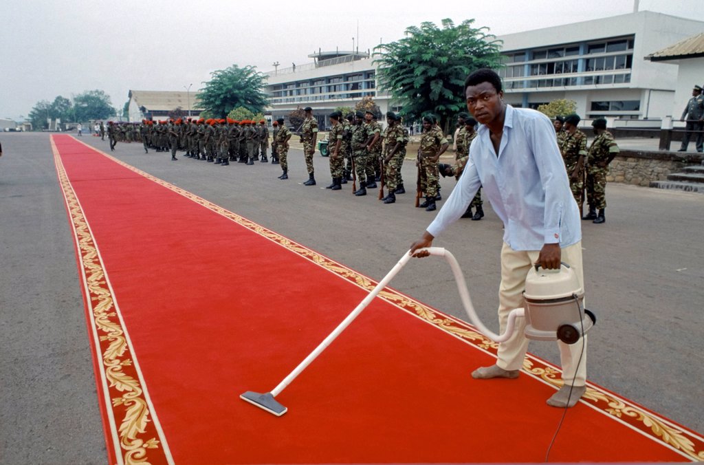 RED CARPET BEING CLEANED READY FOR VIP ARRIVAL IN CAMEROON, WEST AFRICA