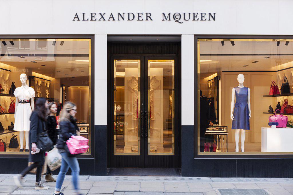 A GROUP OF YOUNG WOMEN WALK BY THE ALEXANDER MCQUEEN FASHION STORE ON OLD BOND STREET