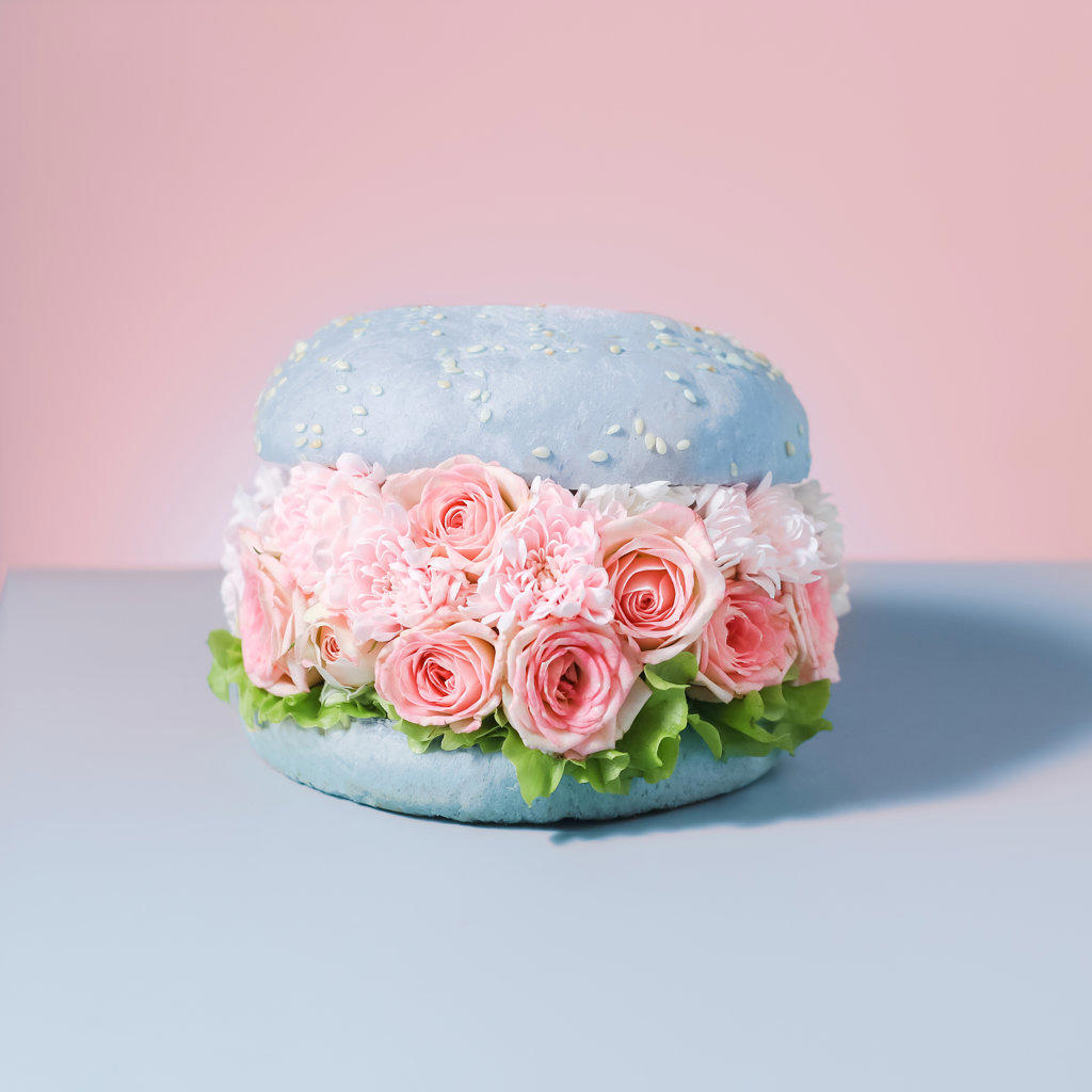 FOOD VEGAN BURGERS WITH FLOWERS ON PINK BACKGROUND