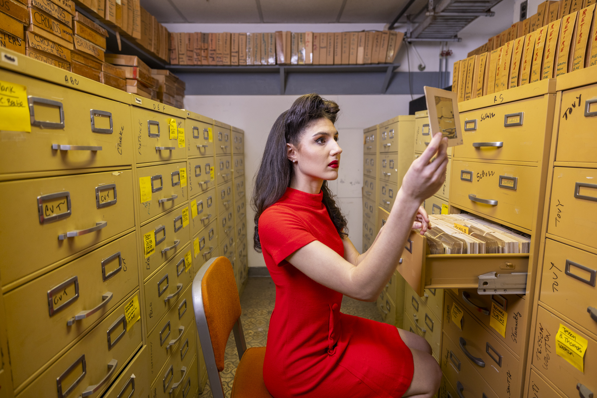 Woman in red examines photographic film